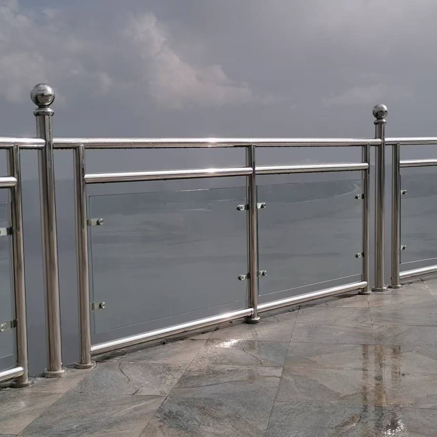 Outdoor balcony railing with stainless posts and glass panels