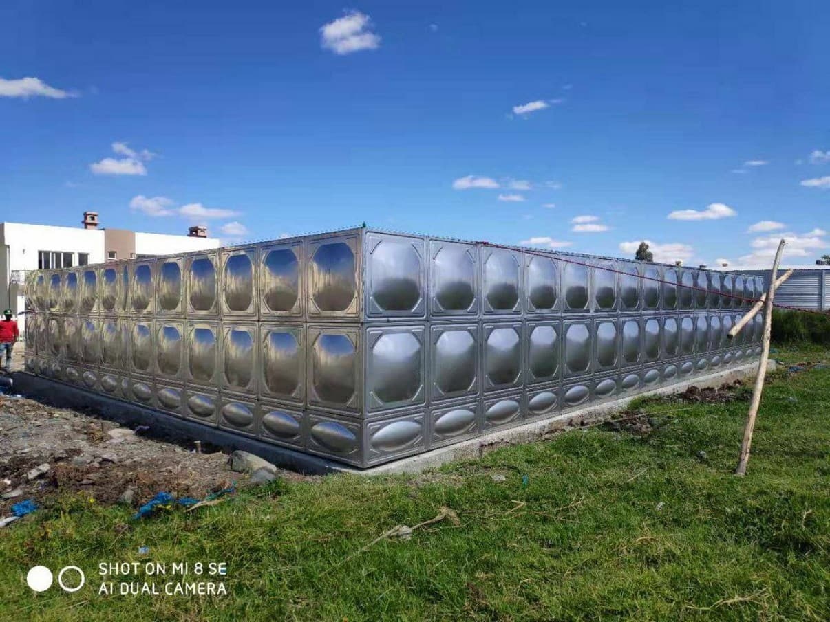 Rectangular sectional stainless tank in an open field